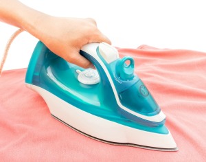 Ironing on an ironing board.