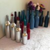 Rows of different colored painted wine bottles.