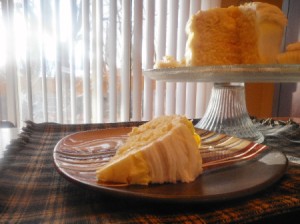 Lemon Vanilla Layer Cake with cut piece