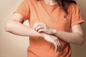 A woman with an itchy spot on her arm.