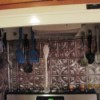 Kitchen Implements Organized - hanging from cup hooks on stove vent