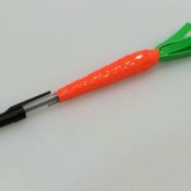 A pen decorated with colored duct tape to resemble a carrot.