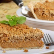A slice of pumpkin pie with streusel topping.