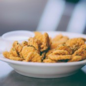 A plate of deep fried dill pickle chips.
