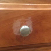 Damage caused by Murphy's Oil Soap on a wooden cabinet.
