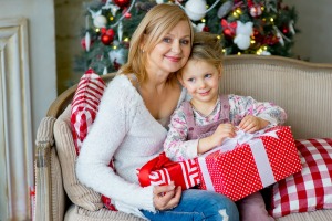 A girl holding a gift from her grandmother.