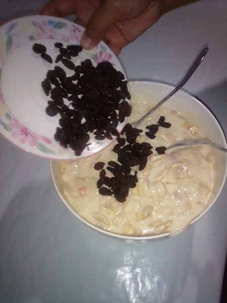 adding cranberries to bowl