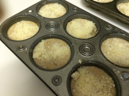filled muffin tins sprinkled with Parmesan cheese