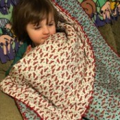 Whole Cloth Tied Quilt with Ric Rac Trim - child under quilt