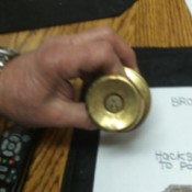 A doorknob lock with a broken key.