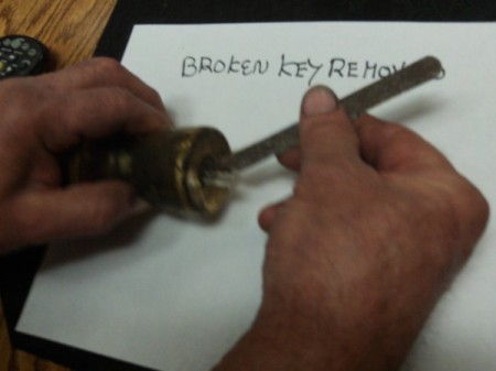 Using a hacksaw to remove a broken key in a lock.