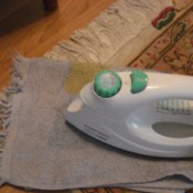 Flattening a Curled Rug - ironing over damp cloth