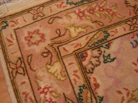 Flattening a Curled Rug - flattened corner of rug