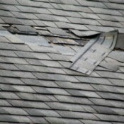 Roof with damaged shingles.