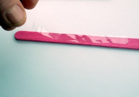 Popsicle Stick Toy Harmonica - lay cellophane on one of the sticks