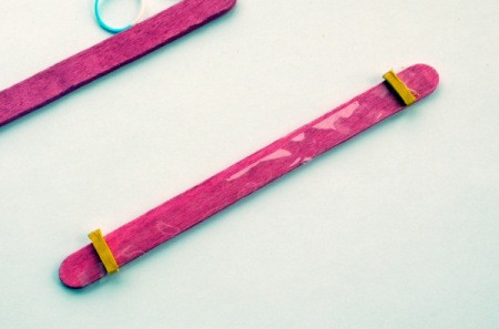 Popsicle Stick Toy Harmonica - place a piece of the splintered stick tip on each end of the stick on top of cellophane