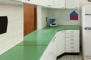 Old kitchen with green laminate countertops.