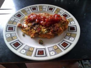 Omelet covered with salsa on plate