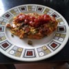 Omelet covered with salsa on plate