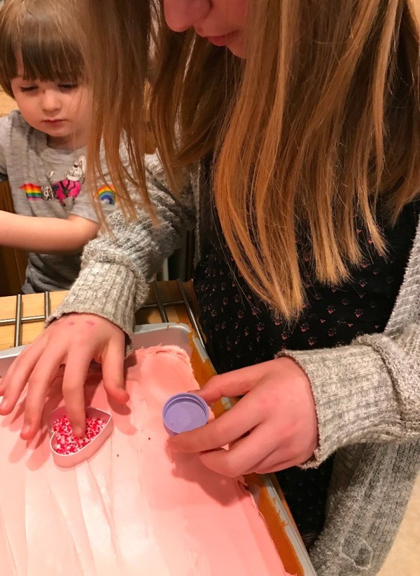 Sprinkle Hearts on a Cake - spreading sprinkles