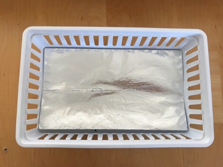 A white basket with a foil liner.