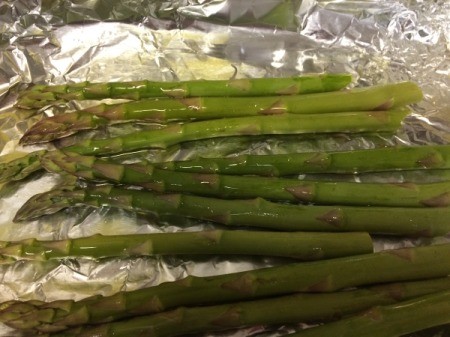 asparagus on foil drizzled with olive oil