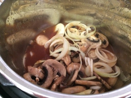 cooked mushrooms and onions added over patties in pressure cooker