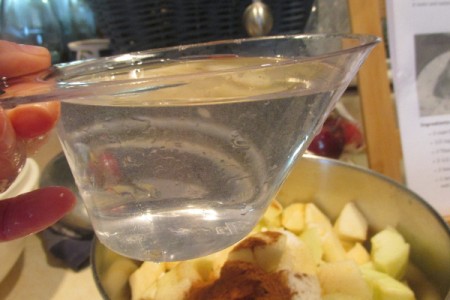 adding cup of water to applesauce