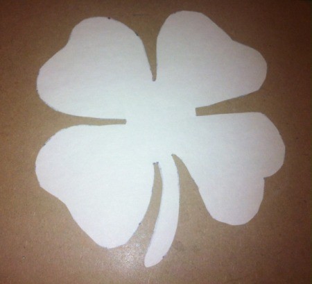 Four-Leaf Clover Collage - cut out four leaf clover on white paper