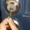 A key being placed into a front door lock.