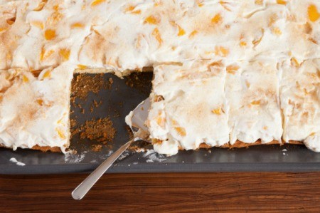 A sheet cake in the pan with frosting.