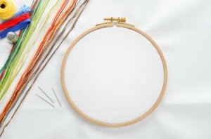 An embroidery hoop set up and ready for a cross stitch project.