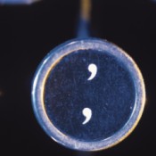 An apostrophe and comma key on an old typewriter.