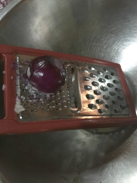 grating onion in bowl
