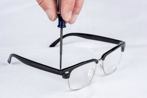 A pair of eyeglasses being repaired.