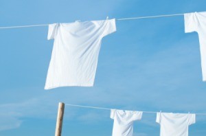 White t-shirts hang drying on clotheslines.