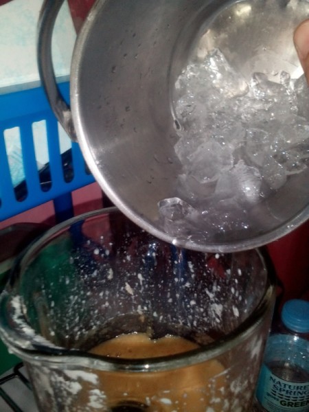 adding ice to smoothie in blender