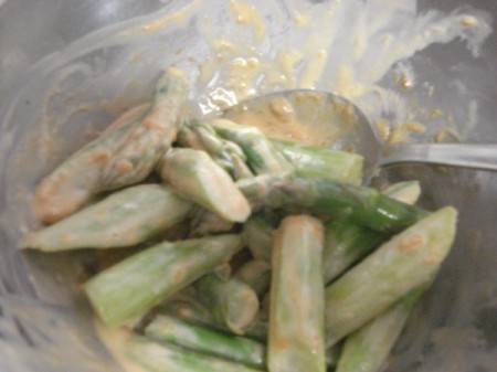 mixing dressing with asparagus