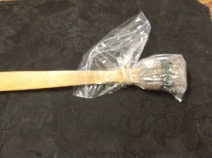 Backscratcher to Apply Lotion - plastic bag over lotion applicator for storage