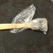 Backscratcher to Apply Lotion - plastic bag over lotion applicator for storage