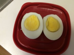 hard boiled egg cut into halves on plate