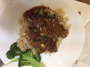 Mongolian Beef on rice with broccoli on plate