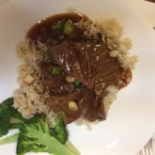 Mongolian Beef on rice with broccoli on plate
