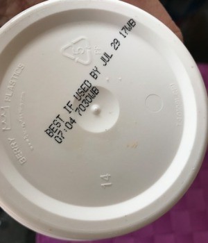 An expiration date on the bottom of a container.