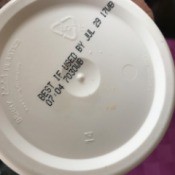 An expiration date on the bottom of a container.