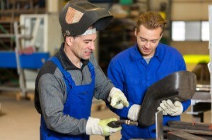 An instructor and student in a welding class.