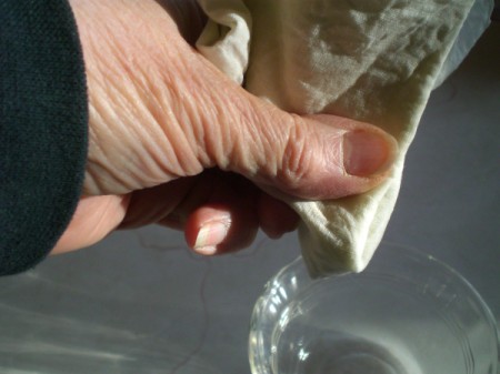 wringing out oil from cloth