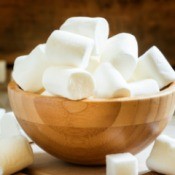 A bowl full of large white marshmallows.