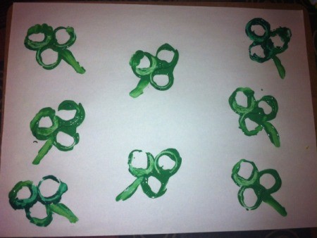 Shamrock Stencil Painting - create shamrocks by dipping stencil into green paint and stamping on the paper