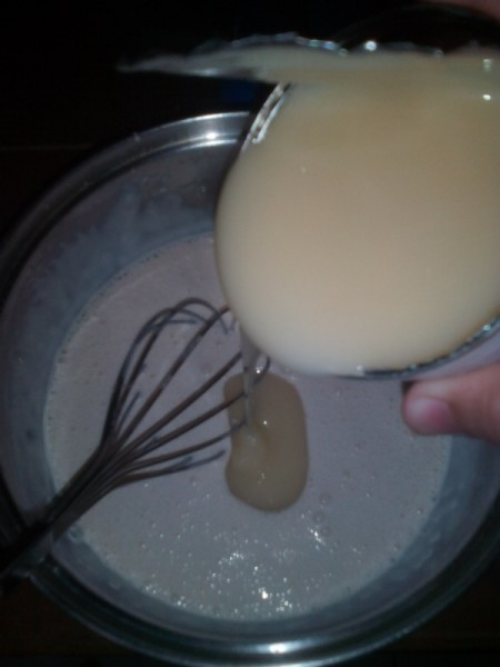 adding evaporated milk to bowl